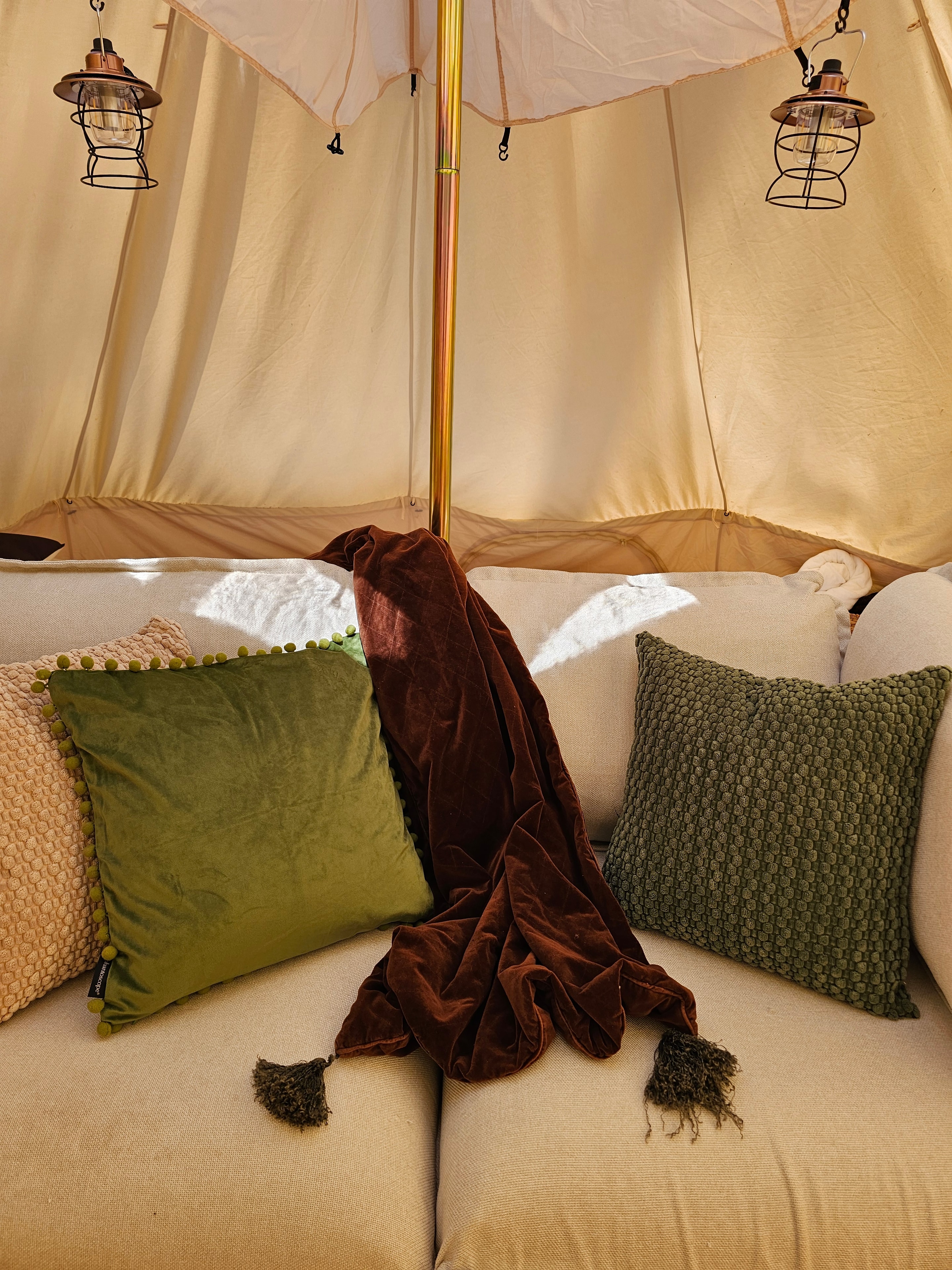 Glamping tent interior with decorative pillows